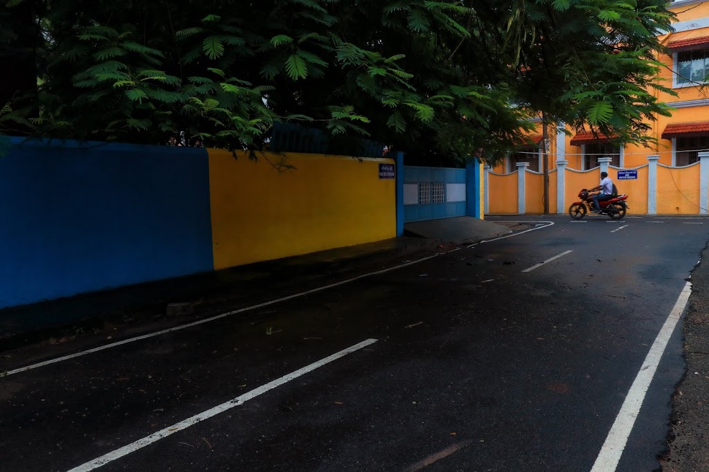An empty street in Pondicherry while a bike rider passing by.