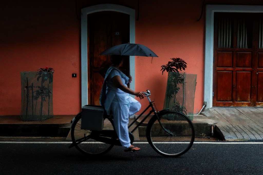 Image of a lady riding a bicycle in White Town in Pondicherry. Bicycle is a common mode of transport inside Pondicherry.
