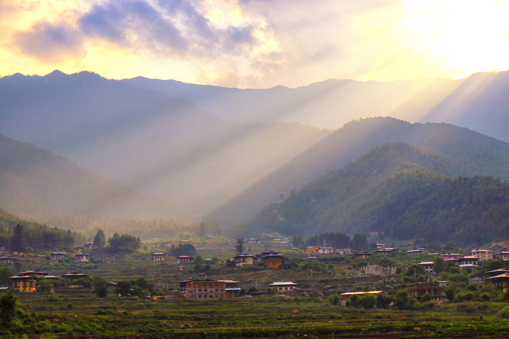 Image of beautiful Paro Valley during sunset. Sun rays peeping out through the cloud, make the valley looks more magical.