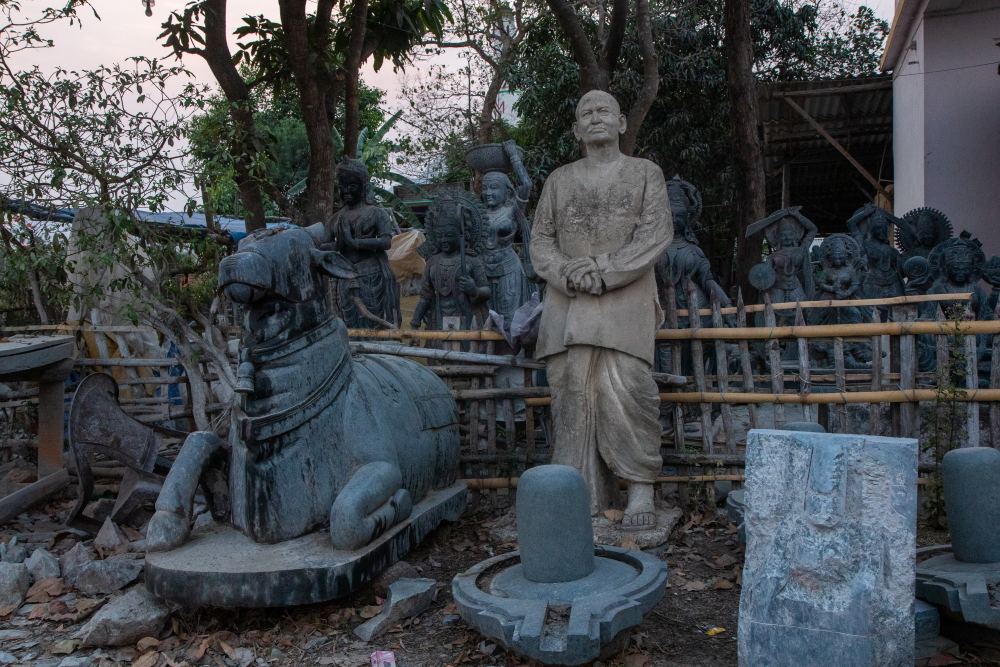 A display of statues and idols in front of a stone carving workshop in Baulagadia village near Panchalingeswar