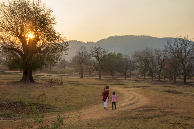 mother and child enjoying sunset over the hills